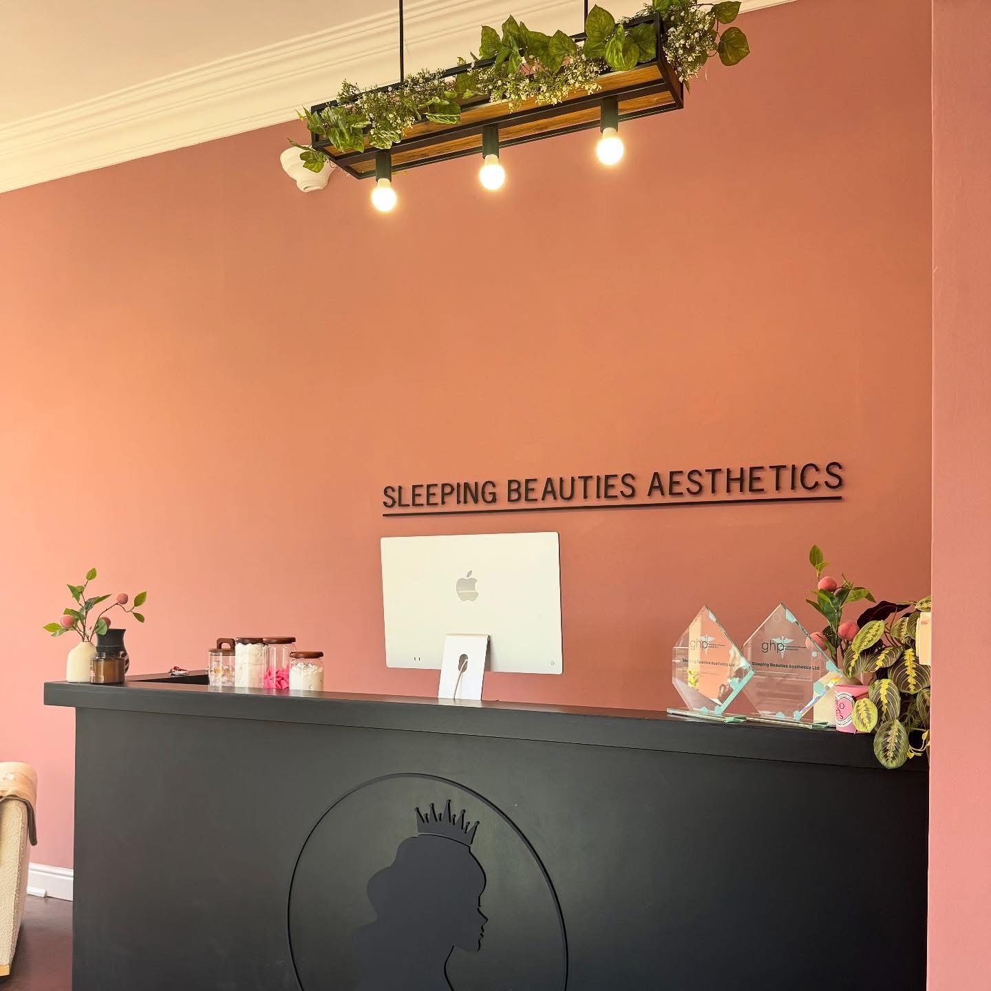 Award trophies on the reception desk at Sleeping Beauties Aesthetics