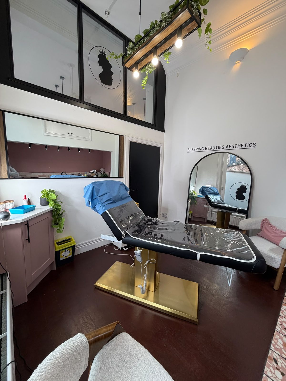 Treatment room with gold treatment bed at the Oxton clinic